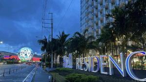 a sign that says welcome in front of a building at Shell Residence MOA Pasay by Kathy in Manila
