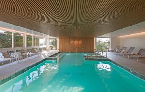 a swimming pool in a house with a wooden ceiling at Varanda Boutique Hotel in Gramado