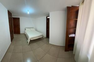 a room with a bed and a book shelf at Real Audiencia Living in Quito