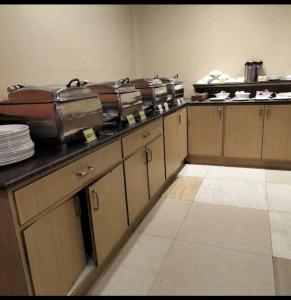 a kitchen with a bunch of dishes on the counter at hotel red creek in Visakhapatnam