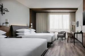 a hotel room with two beds and a desk at hotel red creek in Visakhapatnam