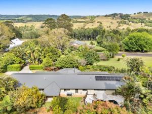 an aerial view of a white house with trees at The Hideaway in Tintenbar