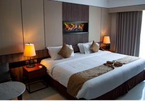 a large bed in a hotel room with two lamps at hotel red creek in Visakhapatnam +3 photos