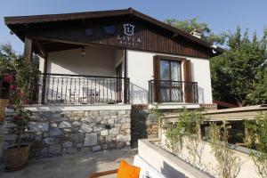 a villa with a balcony and a building at Livia Hotel Ephesus in Selcuk