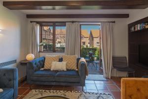 a living room with a blue couch and a window at Monaco Shores Apartment in Nelson