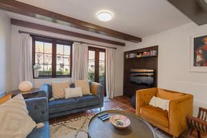 a living room with a couch and a table and chairs at Monaco Shores Apartment in Nelson +30 photos