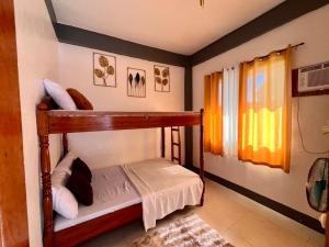 a bedroom with a bunk bed in a room at 88 Tourist Inn by Lagum Adventure in Coron