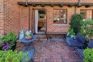 a patio with a table and chairs and a building at Monaco Shores Apartment in Nelson