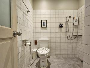 a bathroom with a toilet and a shower at A Day inn Ranong Hostel in Ranong +25 photos