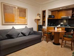 a living room with a couch and a table at The Palmana Courtyard Jayakarta Residence 6 in Seminyak