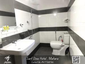 een badkamer met een wit toilet en een wastafel bij Surf Dine in Matara +42 foto's