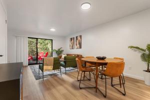 a dining room and living room with a table and chairs at Cedar Terrace Townhome w Firepit in Lynnwood
