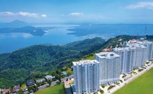 an aerial view of a large building near the water at Idyllic Taal with Modern Vibe 2BR Condo Stunning View - Netflix - 3AC - WiFi in Tagaytay