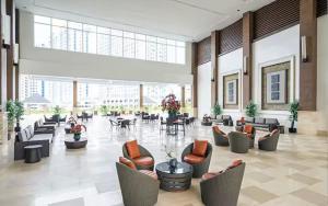 a large lobby with couches and tables in a building at Idyllic Taal with Modern Vibe 2BR Condo Stunning View - Netflix - 3AC - WiFi in Tagaytay