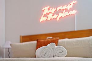 two towels sitting on top of a white couch at New Skywalk Access- Downtown Work Retreat- Sleeps8 in Indianapolis