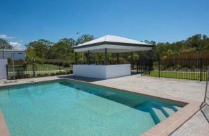 a swimming pool with a gazebo in a yard at Syldah Stay Mango Hills in North Lakes +2 photos