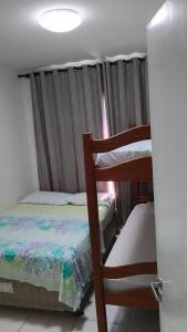 a bedroom with two bunk beds and a window at Muro alto condomínio clube in Ipojuca +50 photos