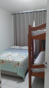 a bedroom with a bed and a bunk bed at Muro alto condomínio clube in Ipojuca