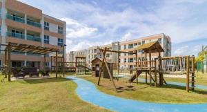a playground in front of a building at Muro alto condomínio clube in Ipojuca