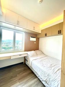 Ένα ή περισσότερα κρεβάτια σε δωμάτιο στο Condo Stay Cebu City