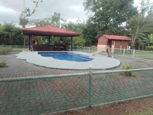 a small swimming pool with a gazebo at Casa Relax La Fortuna in Fortuna