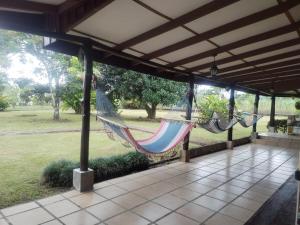 a porch with a hammock and a view of a park at Casa Relax La Fortuna in Fortuna
