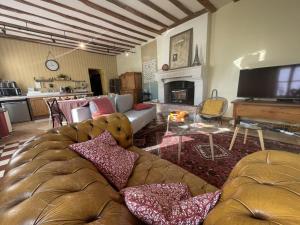 a living room with a couch and a fireplace at Gîte de charme avec parking, animaux admis, proche de Tours - FR-1-381-638 in La Riche