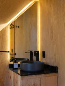 a bathroom with a sink and a mirror at Grasshopper Cabañas in Cuautla Morelos +52 photos