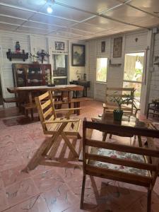 a large room with wooden tables and chairs at Casa Bonsai in Chetumal
