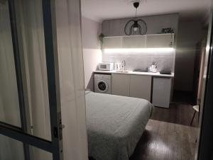 a small kitchen with a bed and a microwave at Beach apartment's in Limassol
