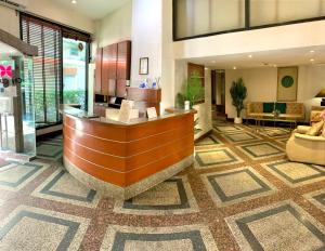 a lobby with a reception desk in a building at City Lodge Bangkok in Bangkok