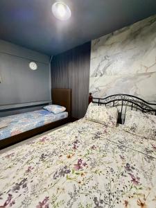 a bedroom with two beds in a room at Bloom&Blossom in Iloilo City