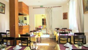 a restaurant with tables and chairs and a dining room at Hôtel du Square d'Anvers in Paris
