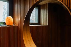 a mirror reflecting a piece of food on a window sill at Villa Amara & Private Spa in Rovaniemi