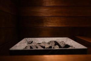 aolith in a sauna with rocks in it at Villa Amara & Private Spa in Rovaniemi +30 photos