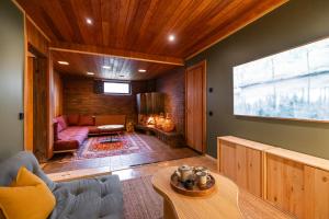 a living room with a couch and a table at Villa Amara & Private Spa in Rovaniemi