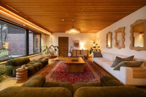 a living room with a couch and a table at Villa Amara & Private Spa in Rovaniemi
