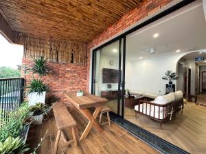 a living room with a brick wall and a table at Wins Residences Hanoi in Hanoi