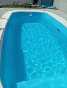 a large blue swimming pool with blue water at Casa Guemes in Victoria