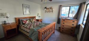 a bedroom with a bed and a dresser and a window at Psycle Ranch Retreat in Durango +12 photos