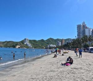 a group of people on a beach in the water at Rodadero Extasis in Puerto de Gaira