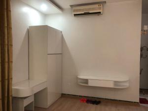 a white kitchen with a refrigerator and a sink at Hotel Nam Sơn Tân Dương in Hai Phong