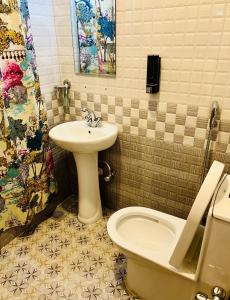 a bathroom with a sink and a toilet and a sink at Himalayan Tranquil Stay in Burhānilkantha