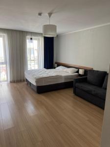 um quarto com uma cama e um sofá em Family room Orbi Palase Deluxe em Bakuriani