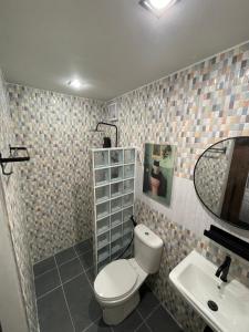 a bathroom with a toilet and a sink and a mirror at The Lamoon Residence samui in Lamai +20 photos