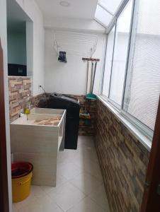 a kitchen with a large window and a sink at comfort house san gil in San Gil