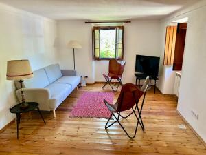 a living room with a blue couch and chairs at Casa do Reguengo (New!) in Castelo de Vide