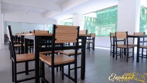 a row of tables and chairs in a restaurant at Lucky Elephant Hotel in Ban Bang Toei (1)