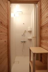 a bathroom with a shower and a table in it at Riviera Iya Valley in Akano +42 photos