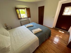 a bedroom with a bed with two towels on it at Casa do Reguengo (New!) in Castelo de Vide